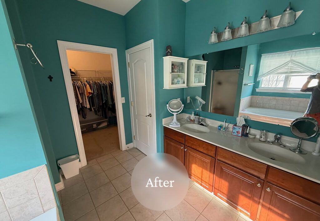 Liminal After Grandmas House 2 A renovated bathroom with teal walls, a double sink vanity, a large mirror, and a walk-in closet visible through an open