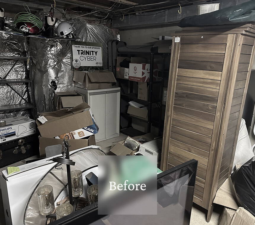 Liminal Before Basement Storage 2 Cluttered storage room with boxes, shelves, a wooden cabinet, and various electronic and household items.