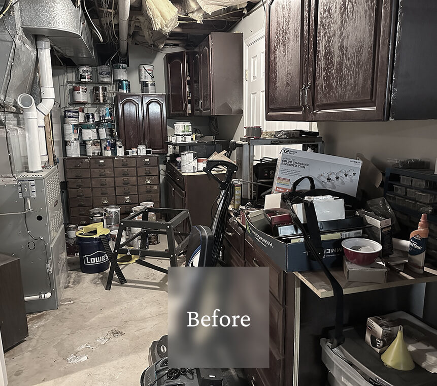Liminal Before Basement Storage 4-1 A cluttered basement workshop with paint cans, tools, cabinets, and various supplies scattered across the space.