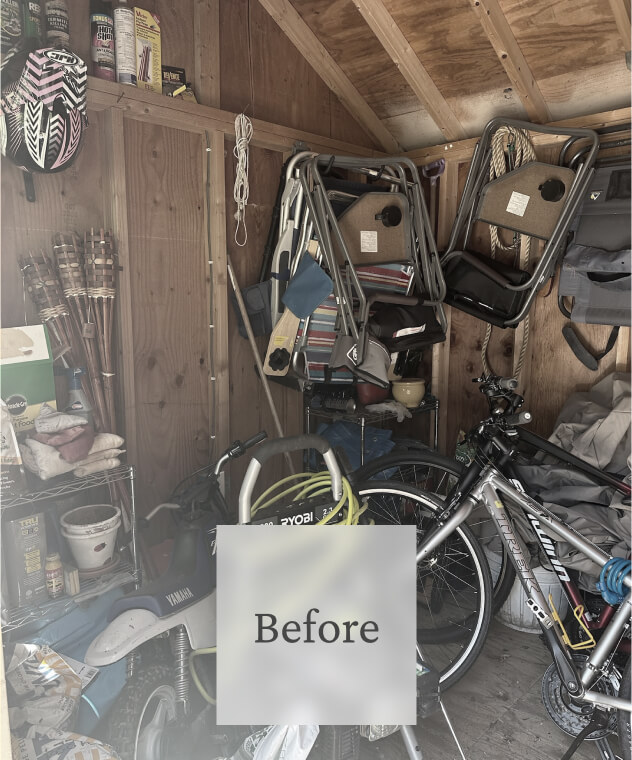 Liminal Before Shed Clean Out 2 Cluttered shed with folded chairs, a bicycle, golf clubs, and various tools and supplies on shelves.