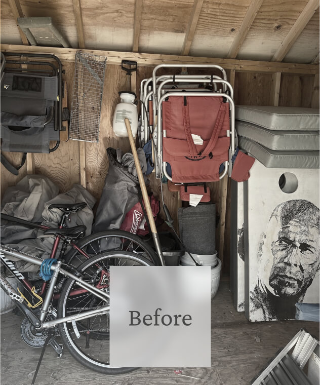 Liminal Before Shed Clean Out 4 A cluttered storage shed with a bicycle, folded chairs, a backpack, gardening tools, and a large portrait of Nelson Mandela.