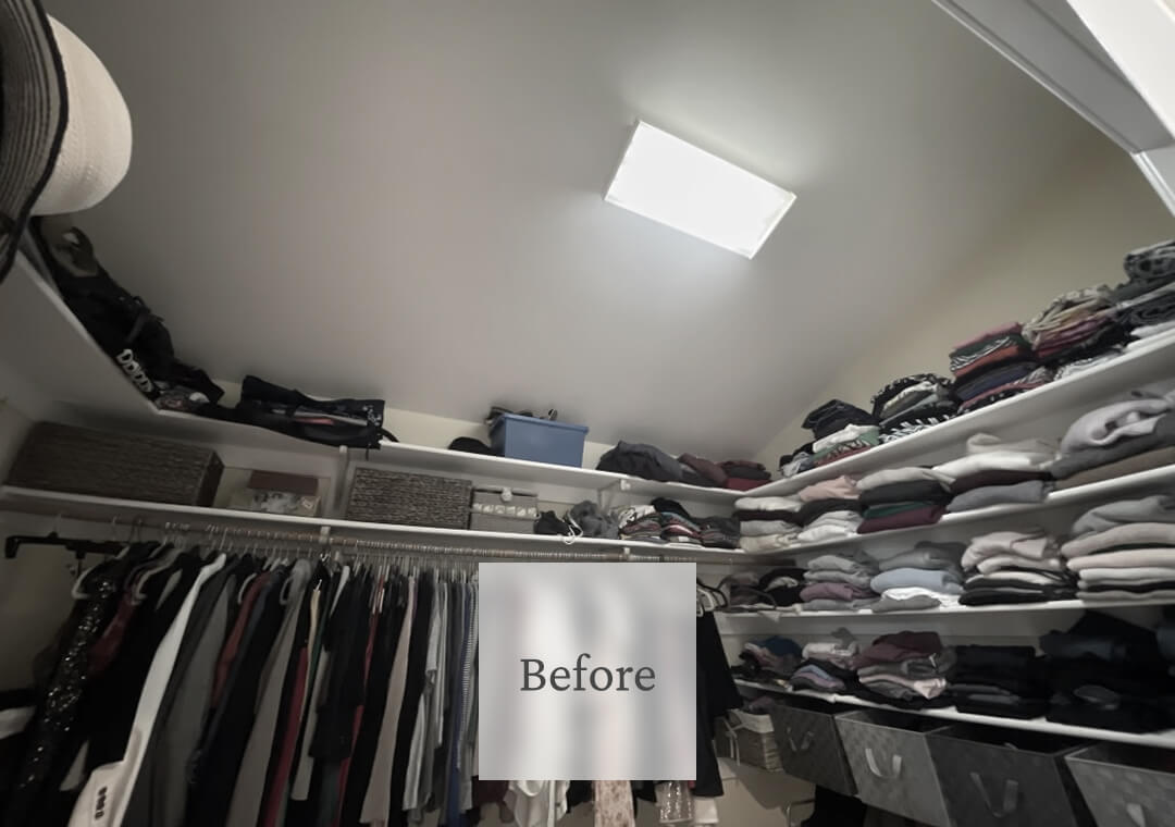Clothes and storage bins are cluttered on shelves and hanging rods in a walk-in closet.